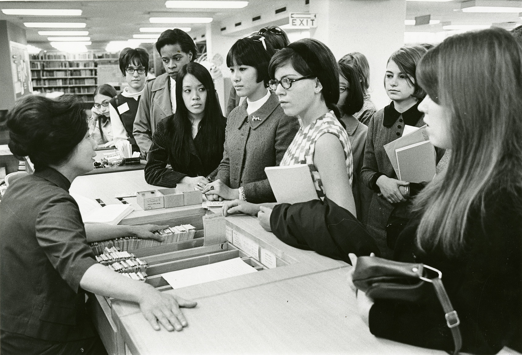 A Barnard librarian assists students at the circulation desk.